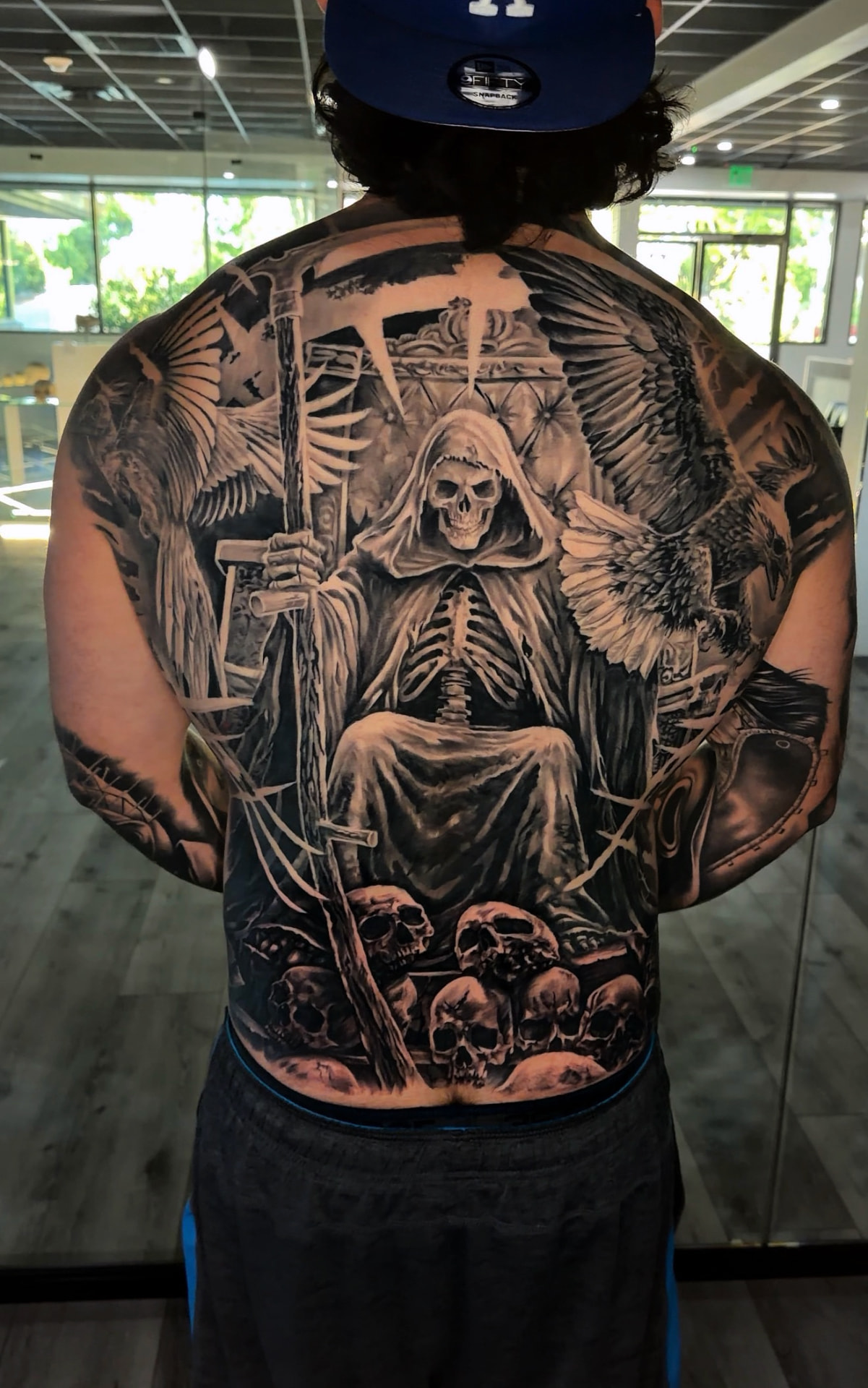 Large-scale grim reaper and ravens back tattoo